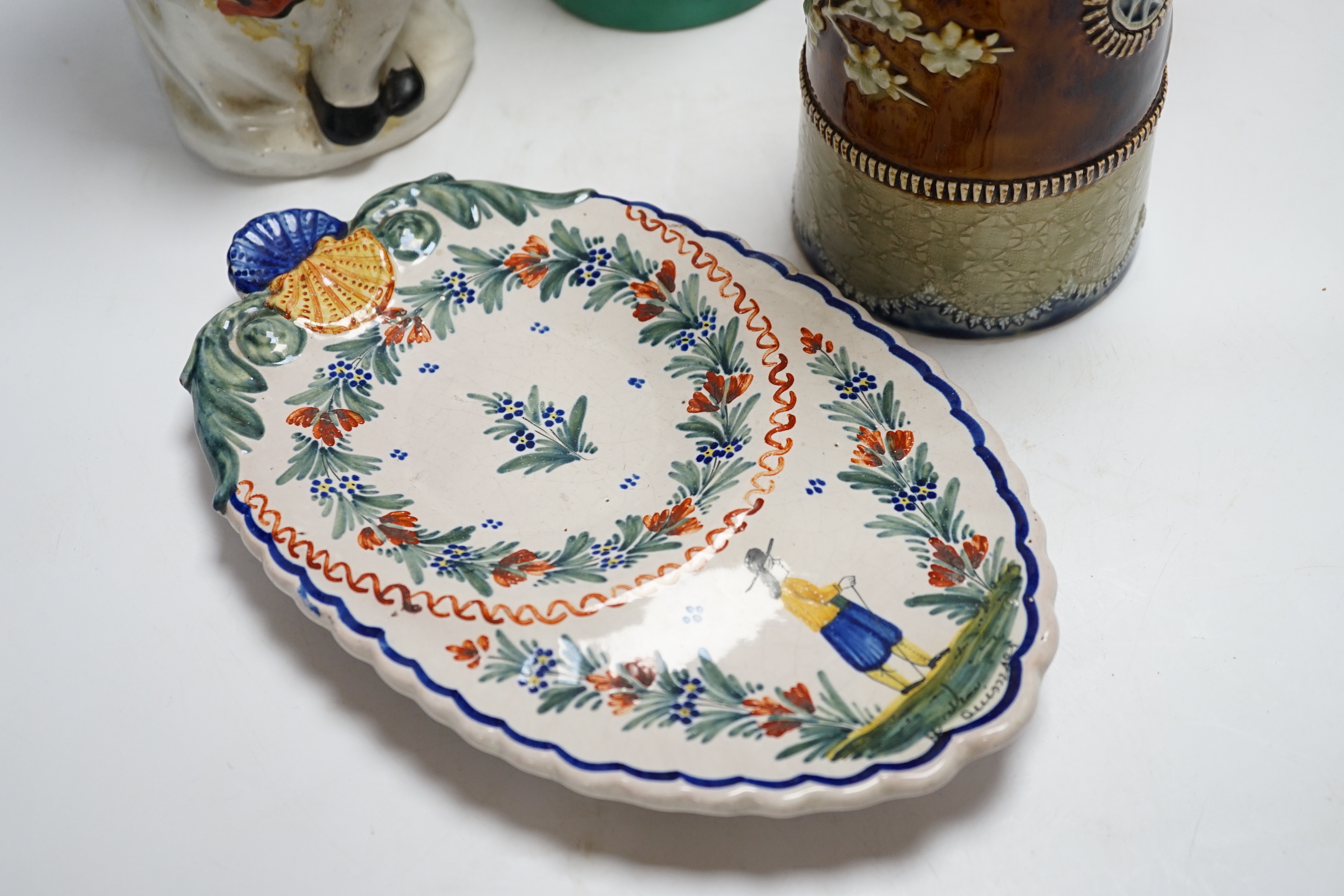A Bisto jug, two other jugs, a Toby jug and a Quimper saucer, tallest 39cm
